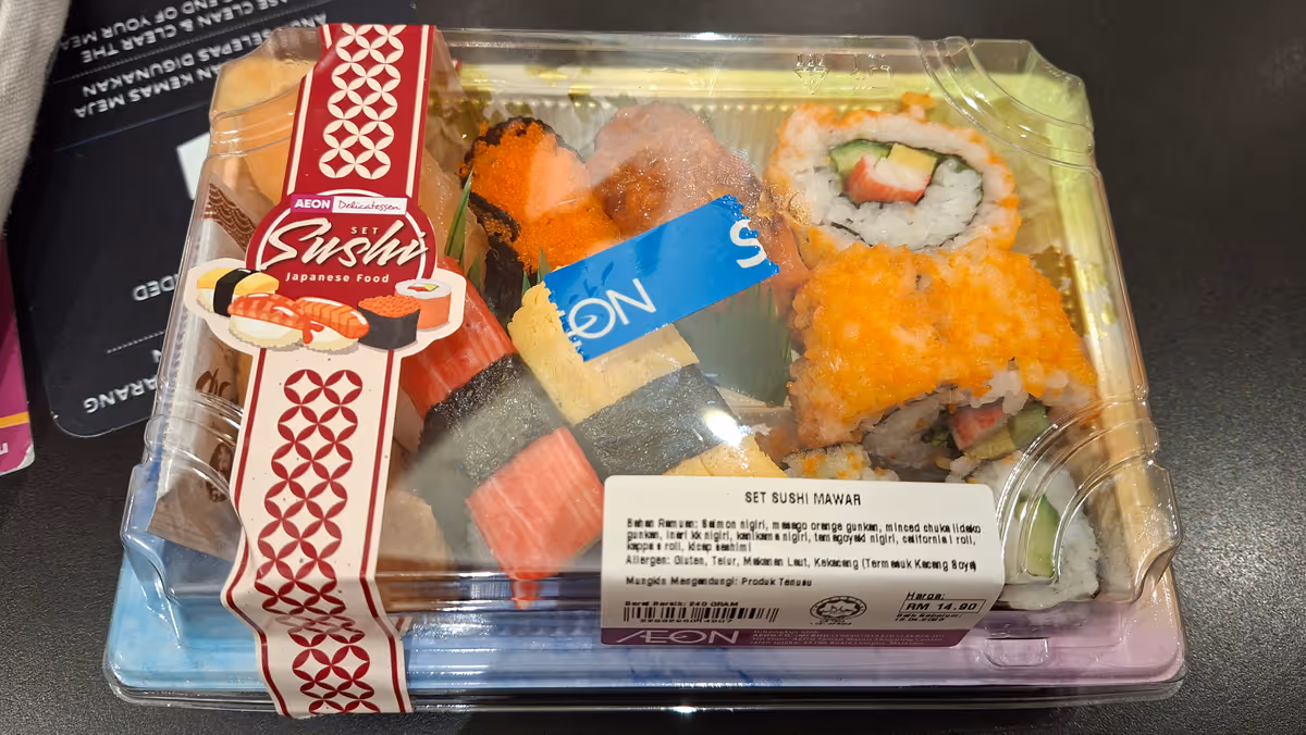 A set of sushi in a clear plastic box with a label on the packaging