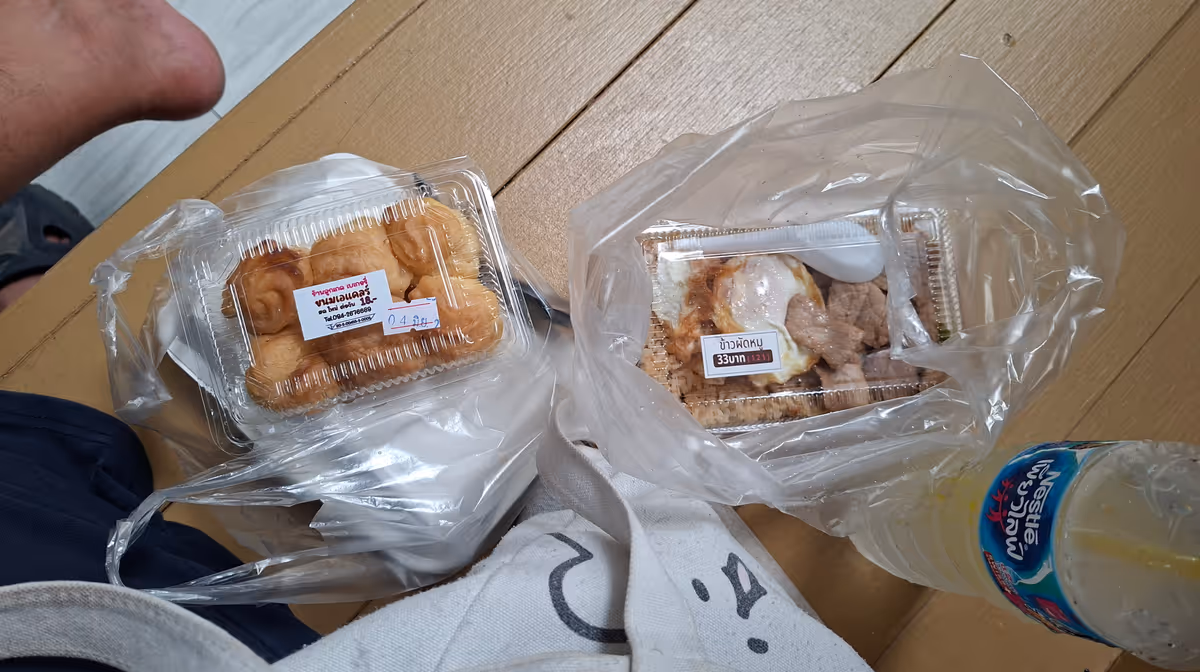 Choux pastry and fried rice pork on a wooden bench.