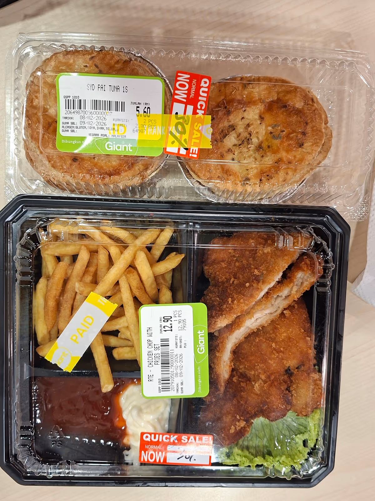 A chicken chop with fries, ketchup, and mayonnaise in a lunchbox, with two tarts in a clear container with a discount label