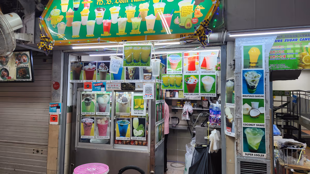 A drinking stall with a colorful images of glasses cover the shop.