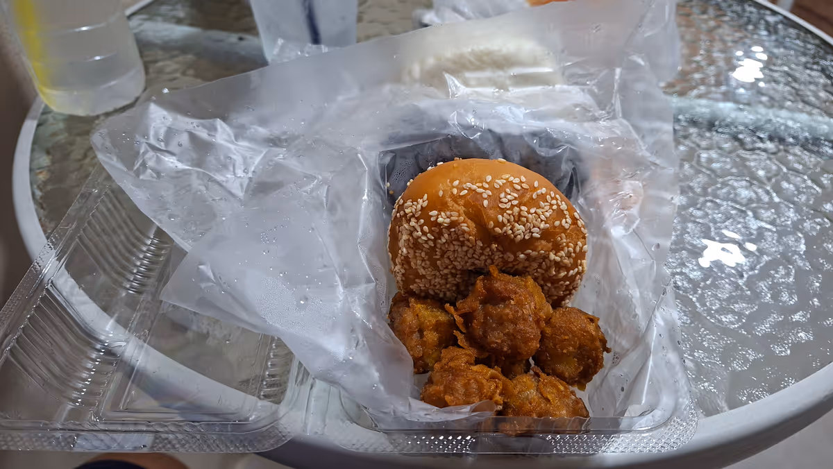 Fried brown shu mai and fried pao on the round table.