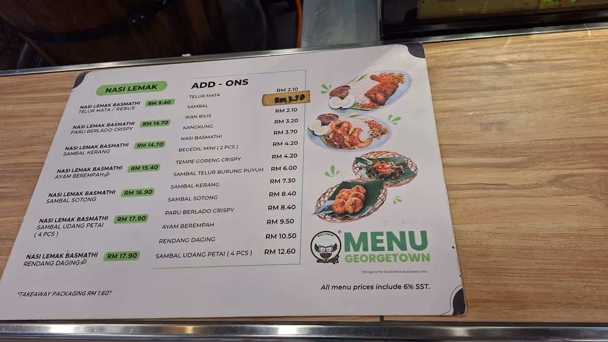 A colorful menu of Nasi Lemak showing prices in local currency, with example images of dishes