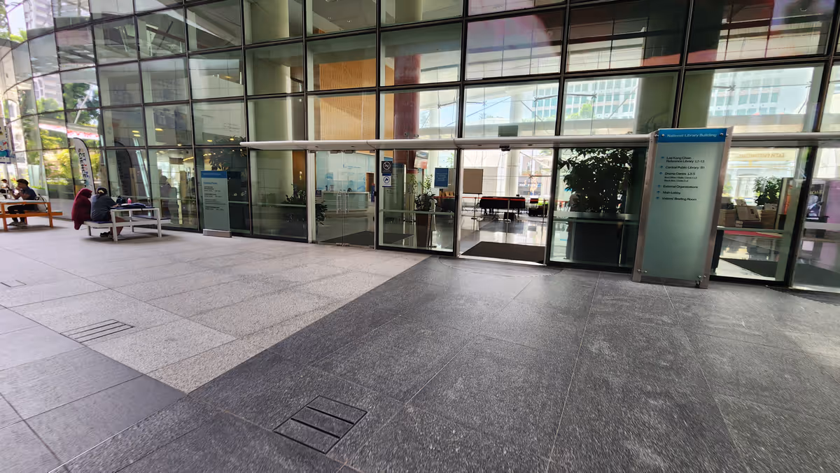 An entrance of the building with transparent wall.
