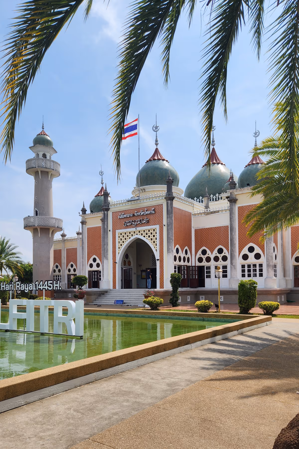 A masjid with a pond in a front.