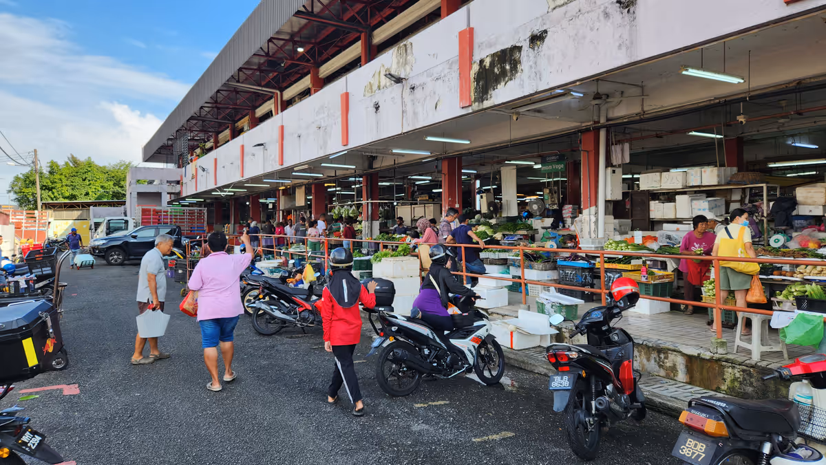 People walk in front of the PJ Oldtown wet market