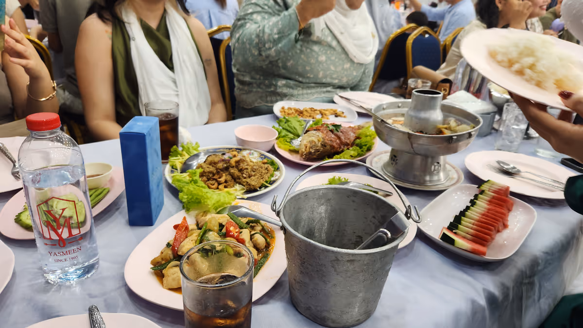 Dishes of foods on the table with blue tablecloth.