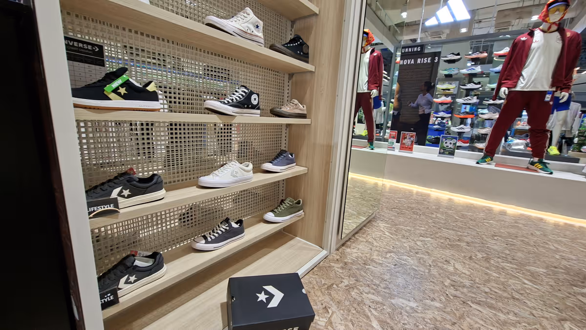 Shoes on the shelf in the sport store and a mannequin.