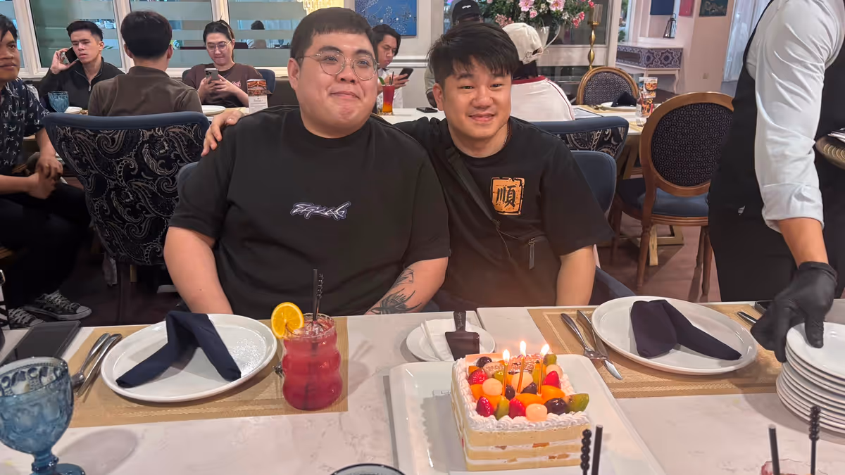 2 men and birthday cake